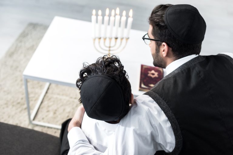 overhead view of jewish father hugging son in apartment