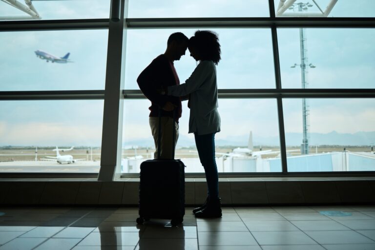Airport, couple and silhouette of love, hug and leaving on vacation on a airplane flight. Plane dep