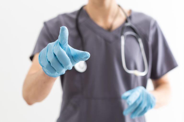 View of a Doctor pointing his finger at the clinic.